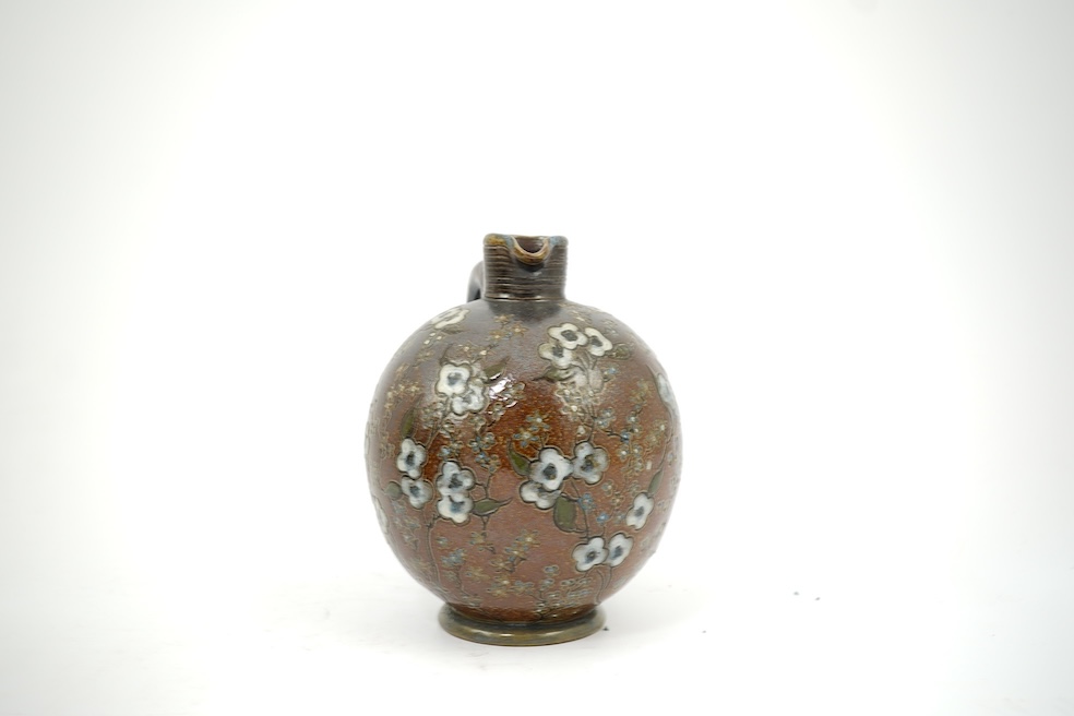 Martin Brothers: A stoneware jug decorated with flowers